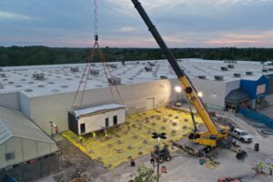 Superior Rigging & Erecting. Co using an all-terrain crane to lift and set equipment.